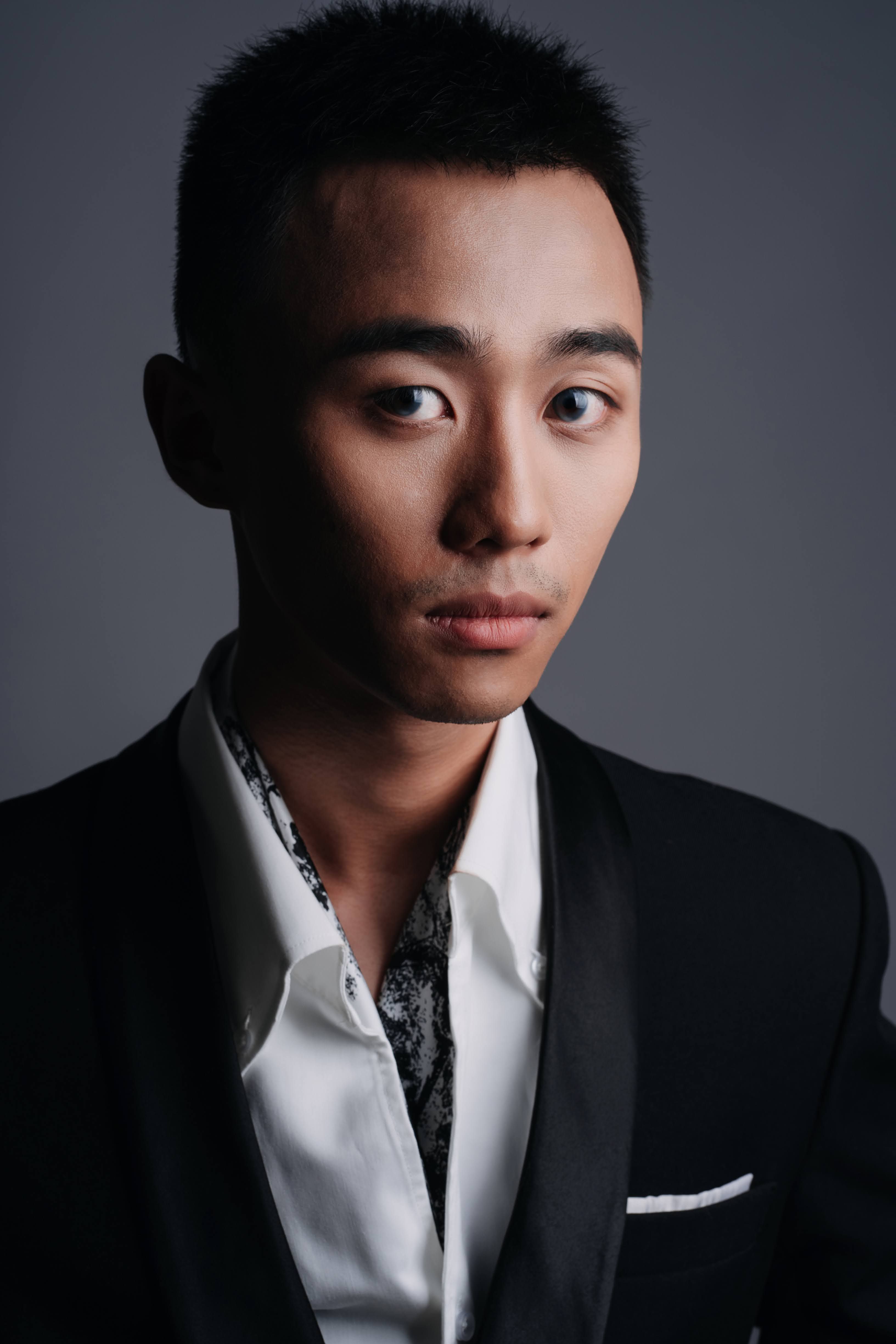 Free Striking portrait of an Asian man in a fashionable suit, capturing elegance and sophistication. Stock Photo