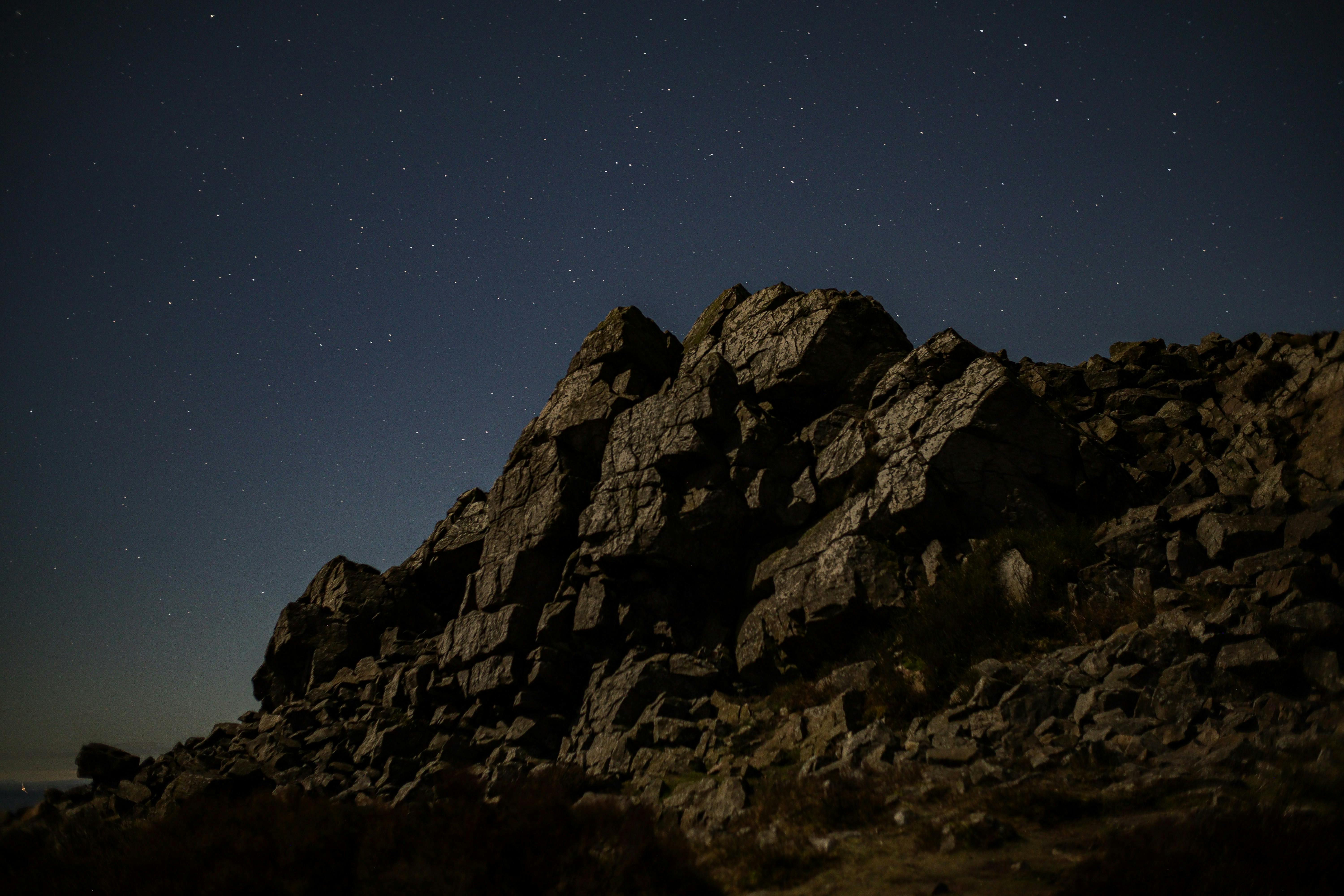 A breathtaking night view of the rocky landscape at Stiperstones, England, illuminated by a clear starry sky.