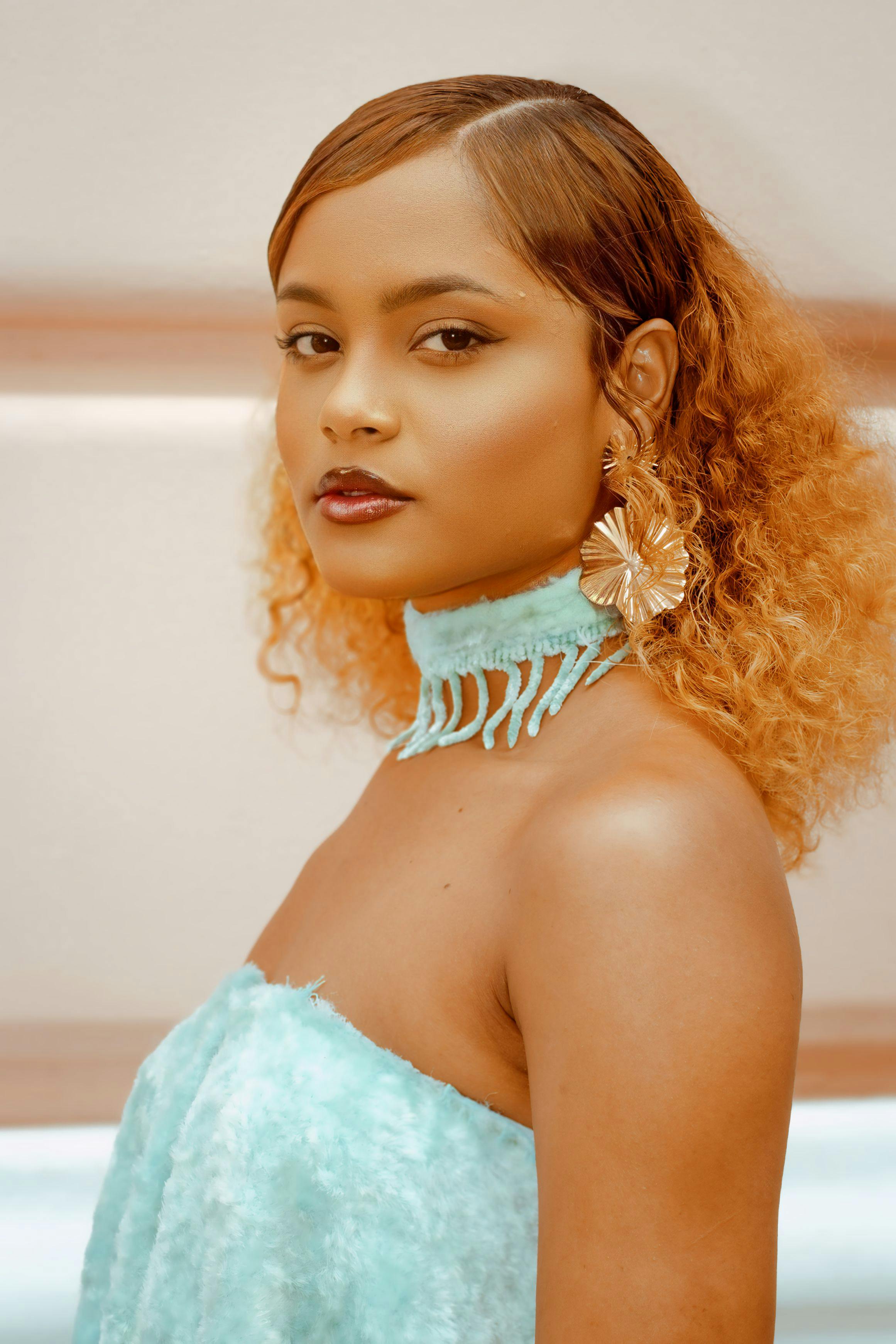 a woman with curly hair wearing a dress