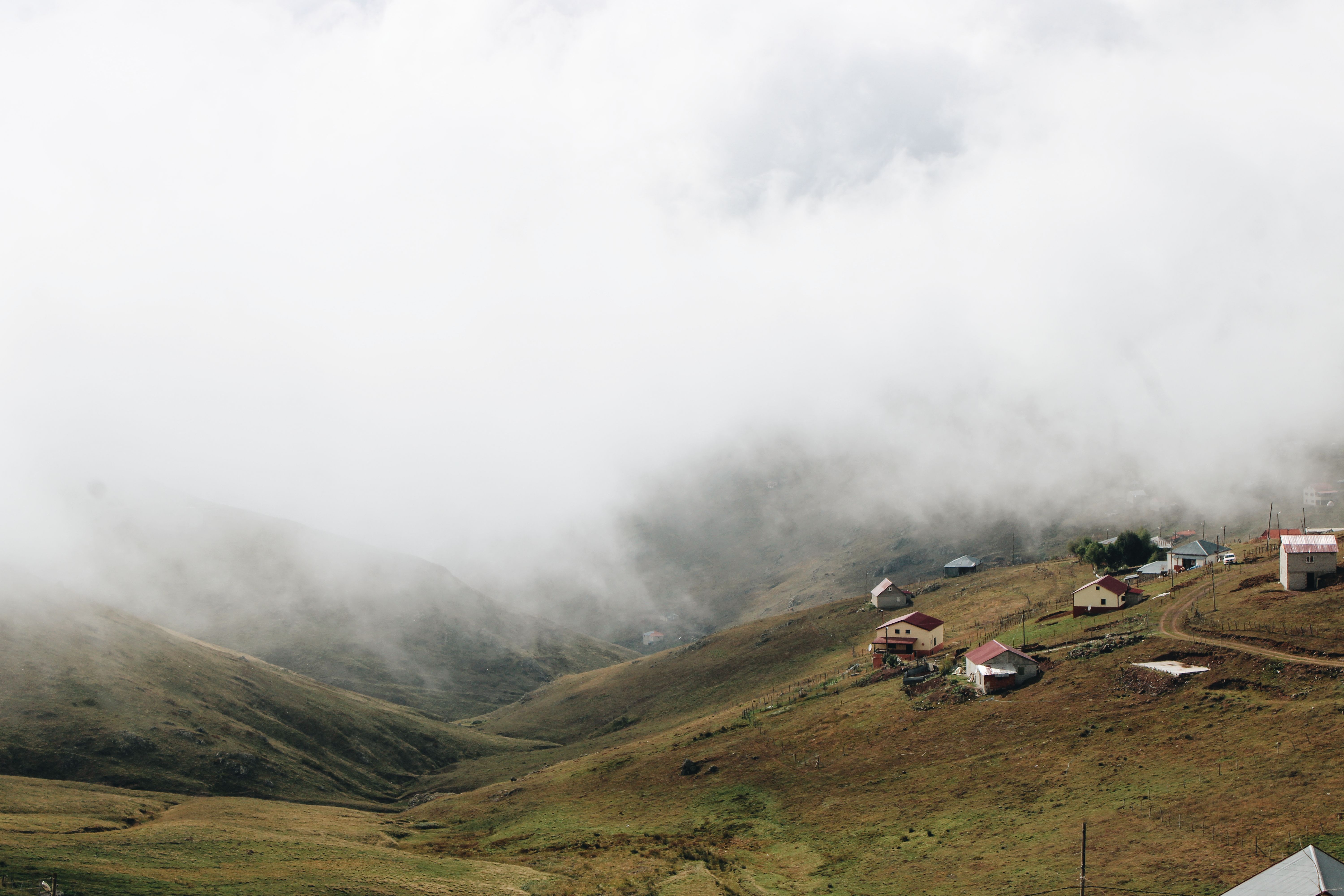 A hillside village landscape under an overcast sky