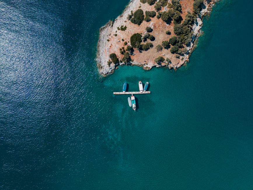 Best Antalya Unforgettable Helicopter Adventure Review: A Bird's-Eye Journey Over Turkey's Stunning Riviera Review 2026 - Stunning aerial view of boats moored at a dock in Muğla, Türkiye, with a turquoise sea.