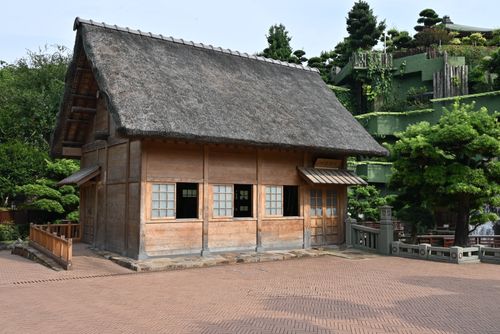 Free A rustic Tang Dynasty style building in Nan Lian Garden, Hong Kong with a thatched roof. Stock Photo