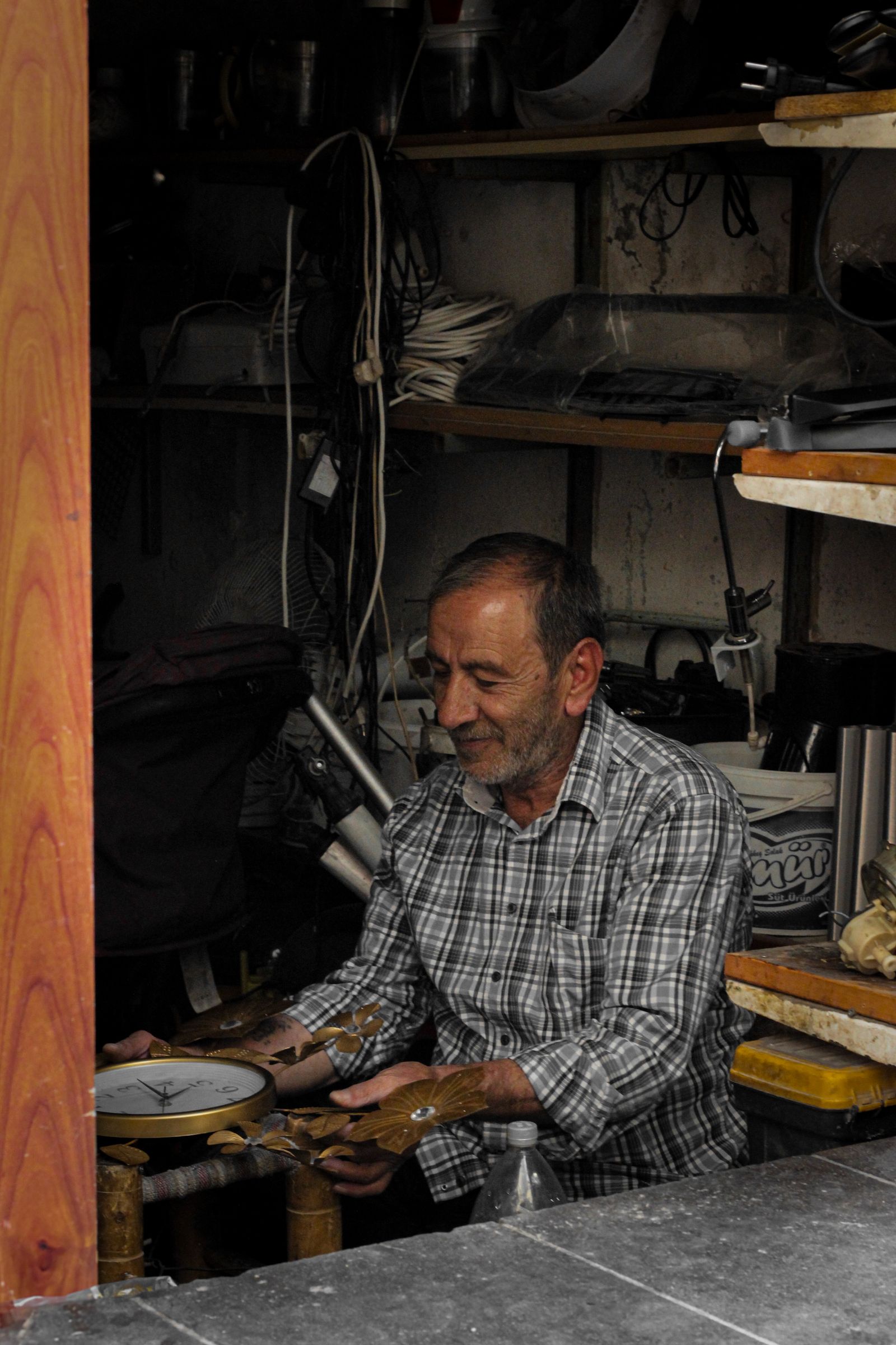 An independent craftsperson working with tools in a small workshop
