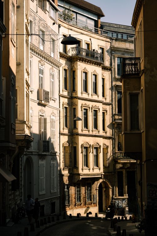 Free Sunlit street showcasing vintage urban architecture and intricate facades. Stock Photo