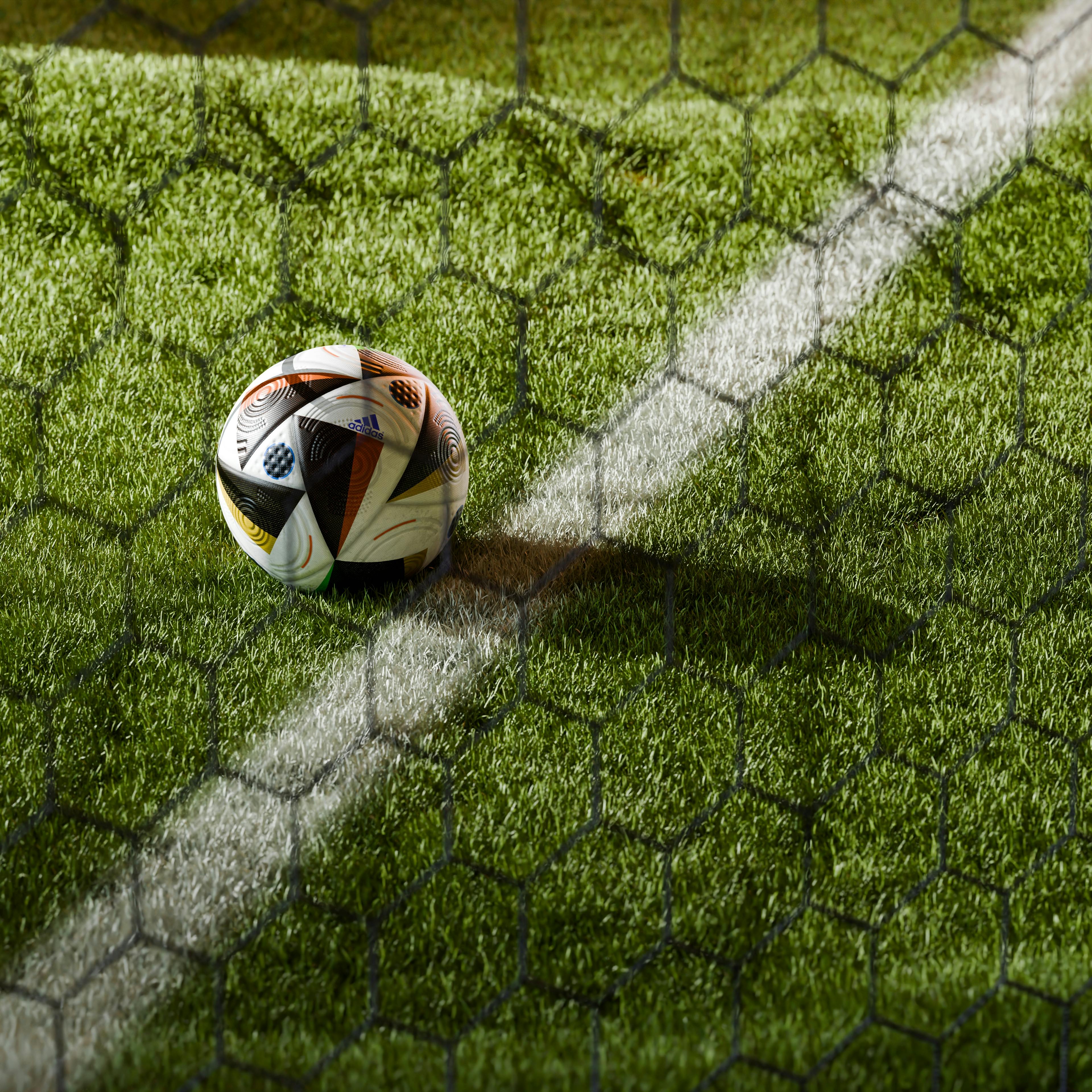 soccer ball in net on field