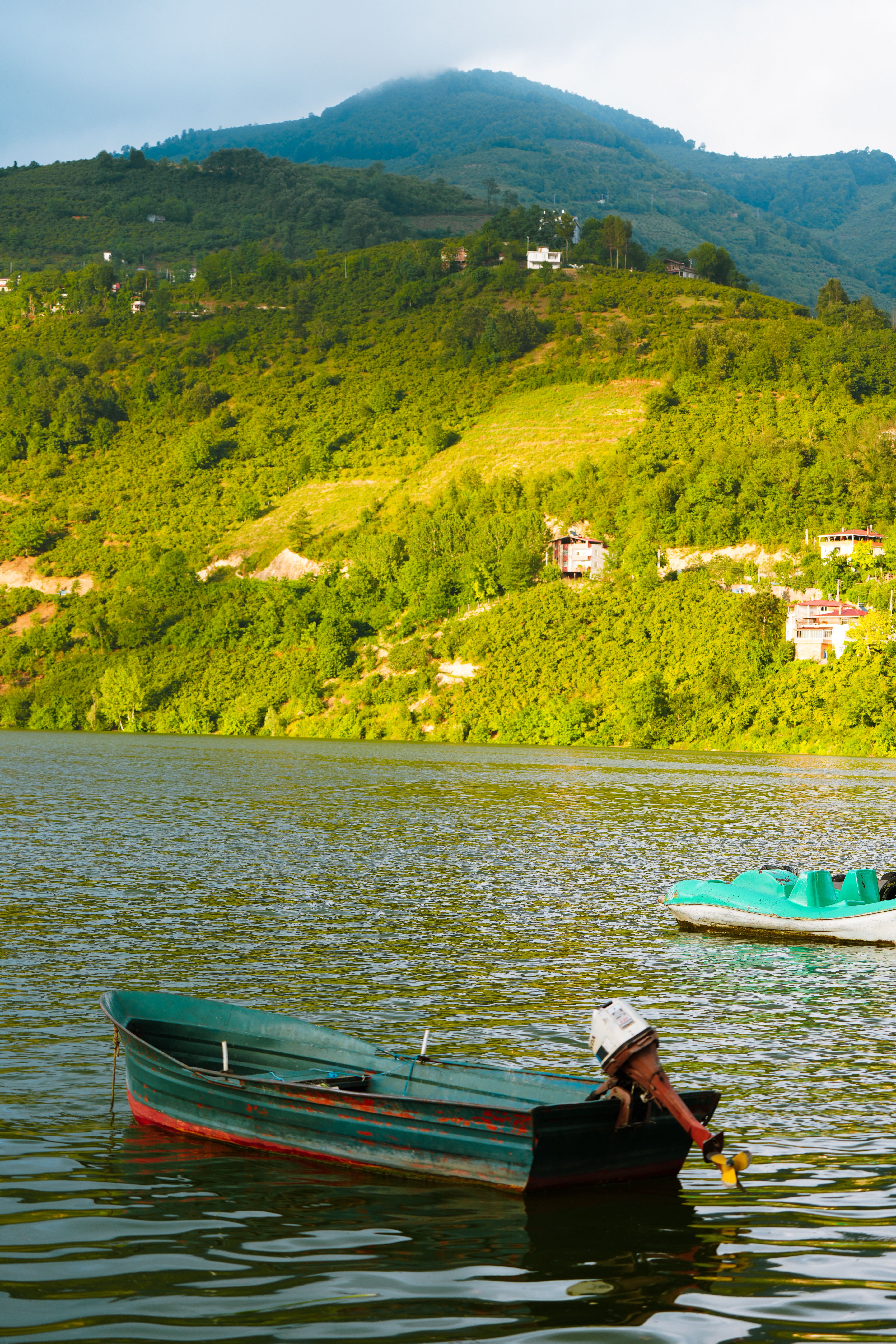 A man is sitting in a boat on the water · Free Stock Photo