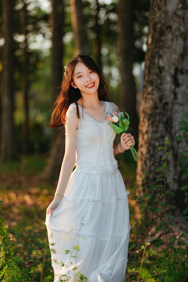 Woman wearing a white dress in summer daytime