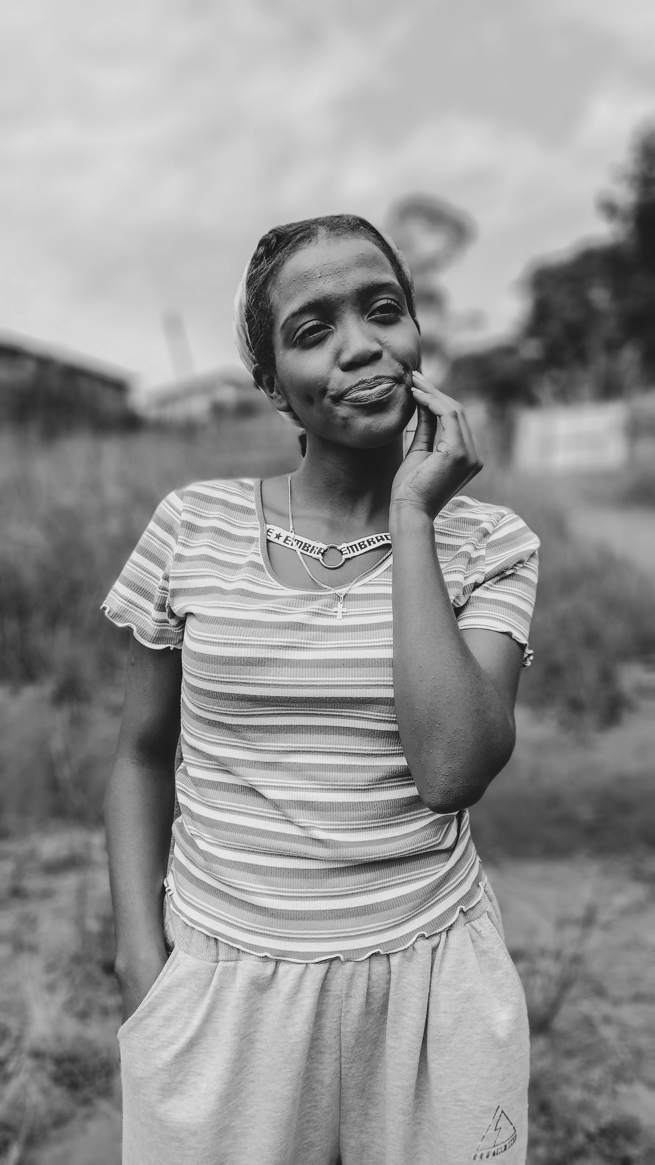 a black and white photo of a woman smiling