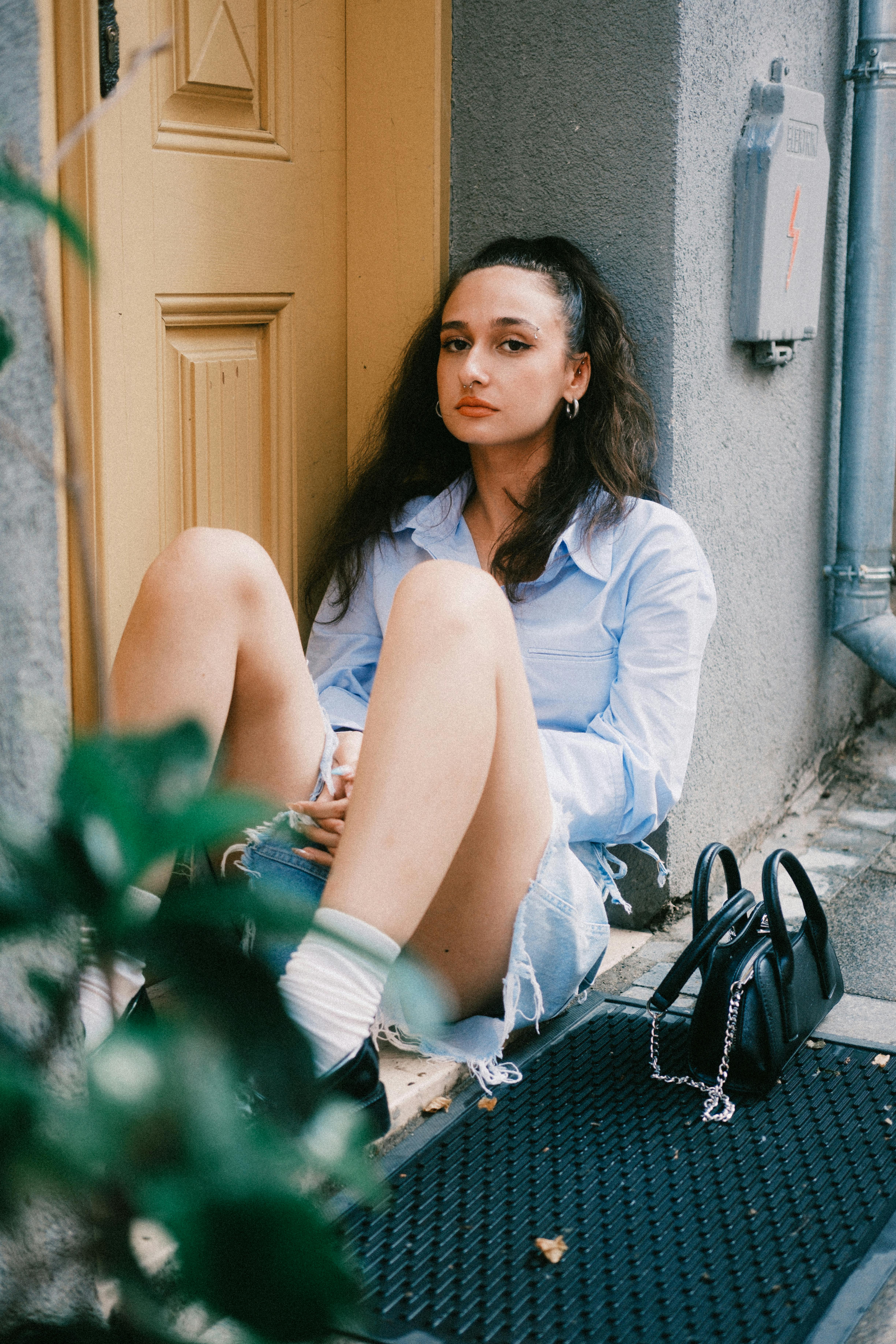 a woman sitting on the steps of a building