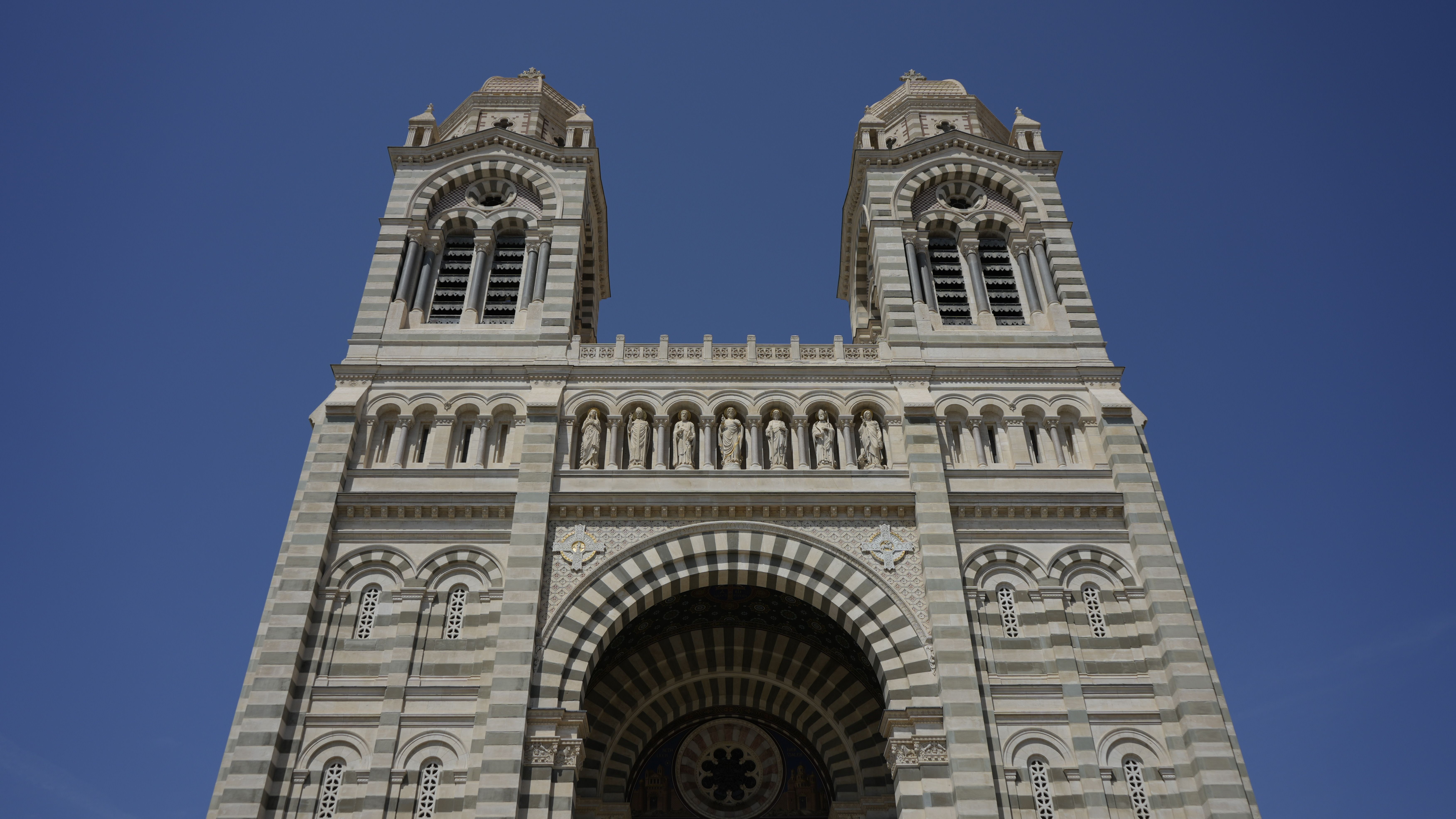Close-up of the Marseille Cathedral facade with clear blue sky backdrop.
