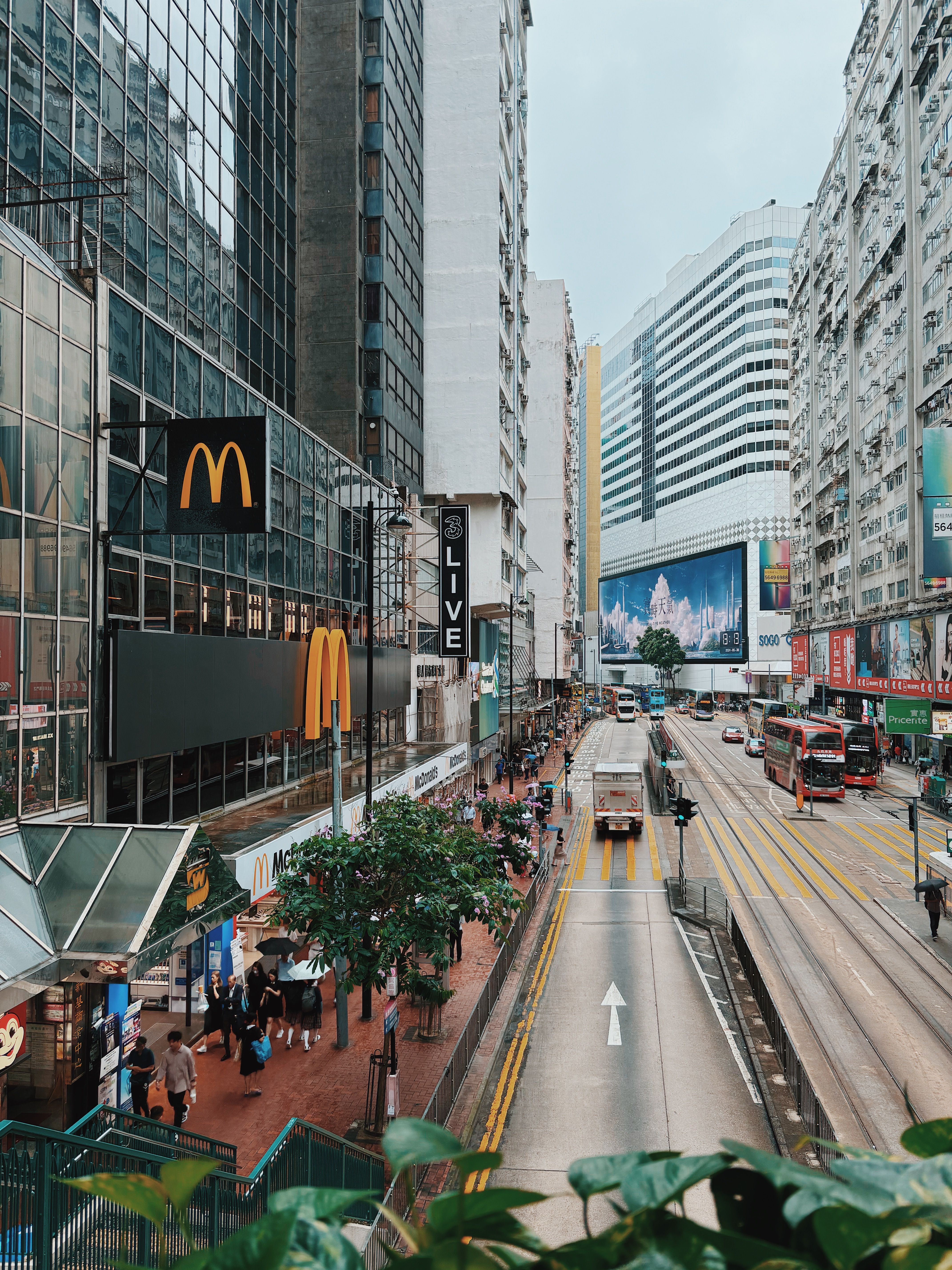 Vibrant cityscape of Causeway Bay with trams and city life in Hong Kong.