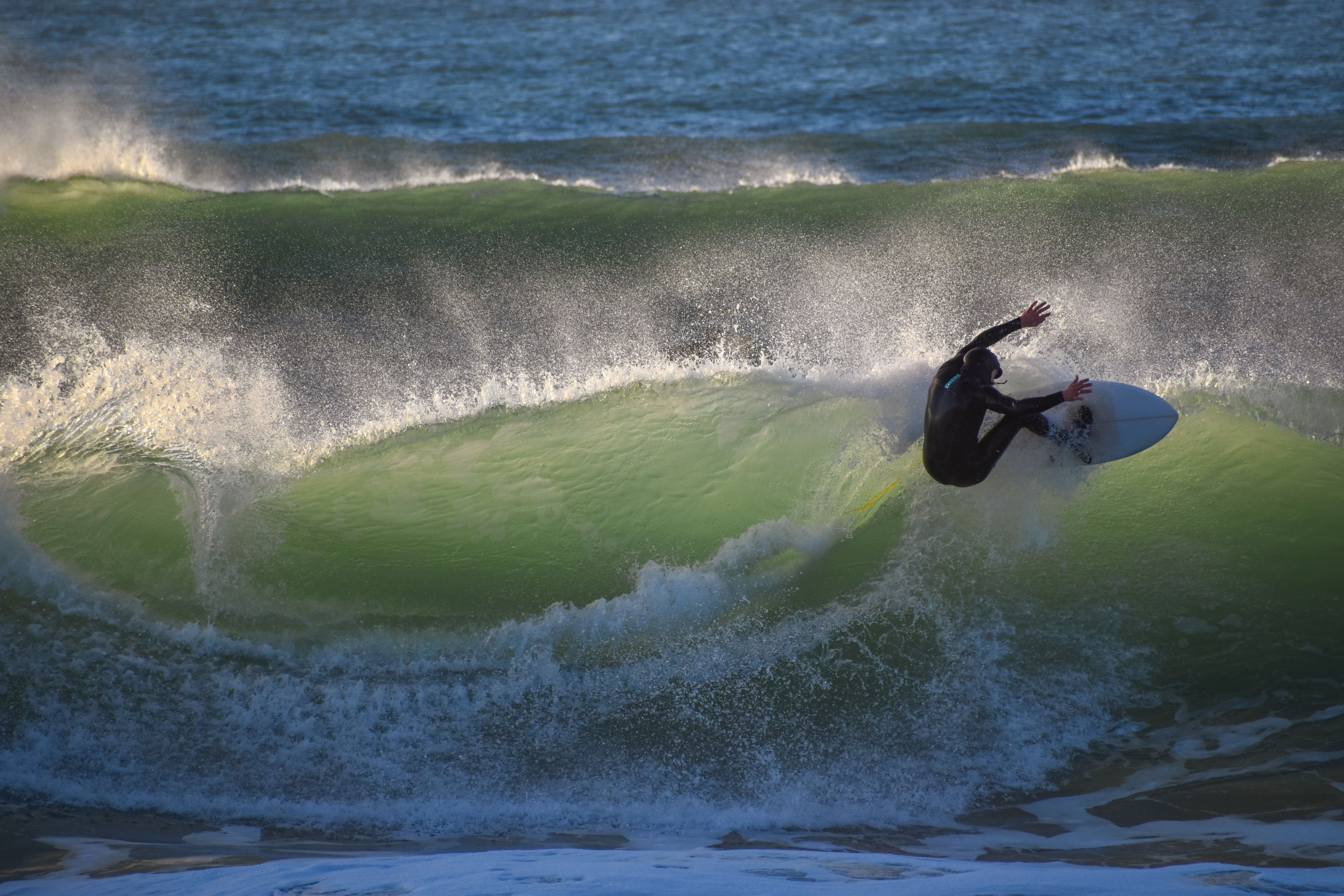 Surfer skillfully rides a wave in the ocean