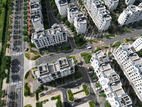 Aerial view of modern white apartment buildings in Đồng Nai, Vietnam, surrounded by lush greenery and roads.