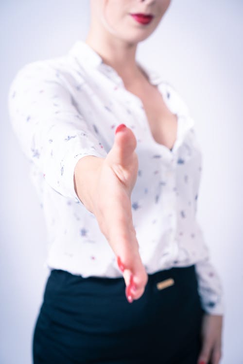 Woman Wearing White Top With Hand Reaching Out