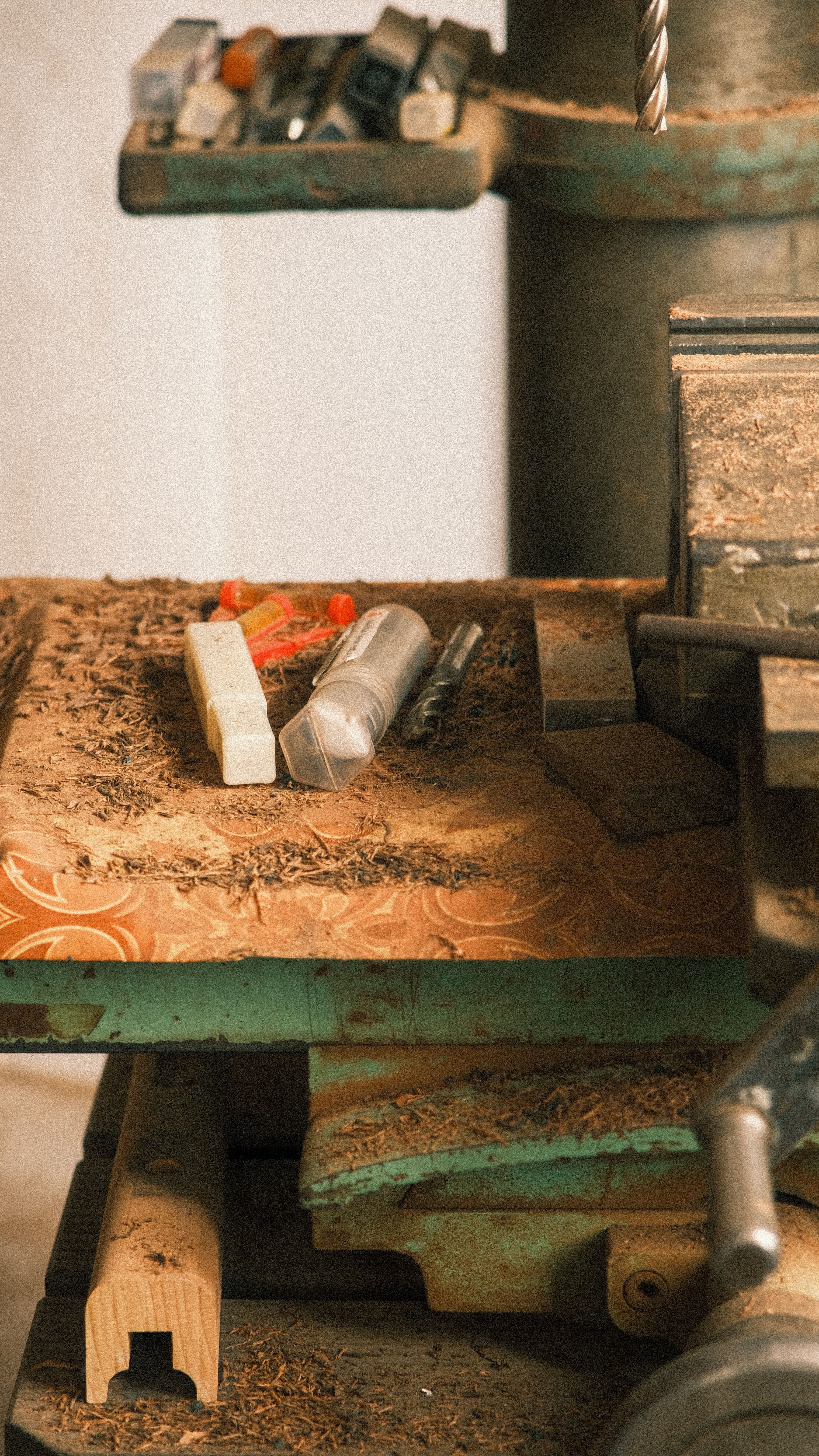 A workshop bench with metal samples and measuring tools laid out