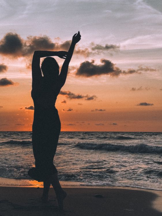 Back View of Woman Posing on Sea Shore at Sunset · Free Stock Photo