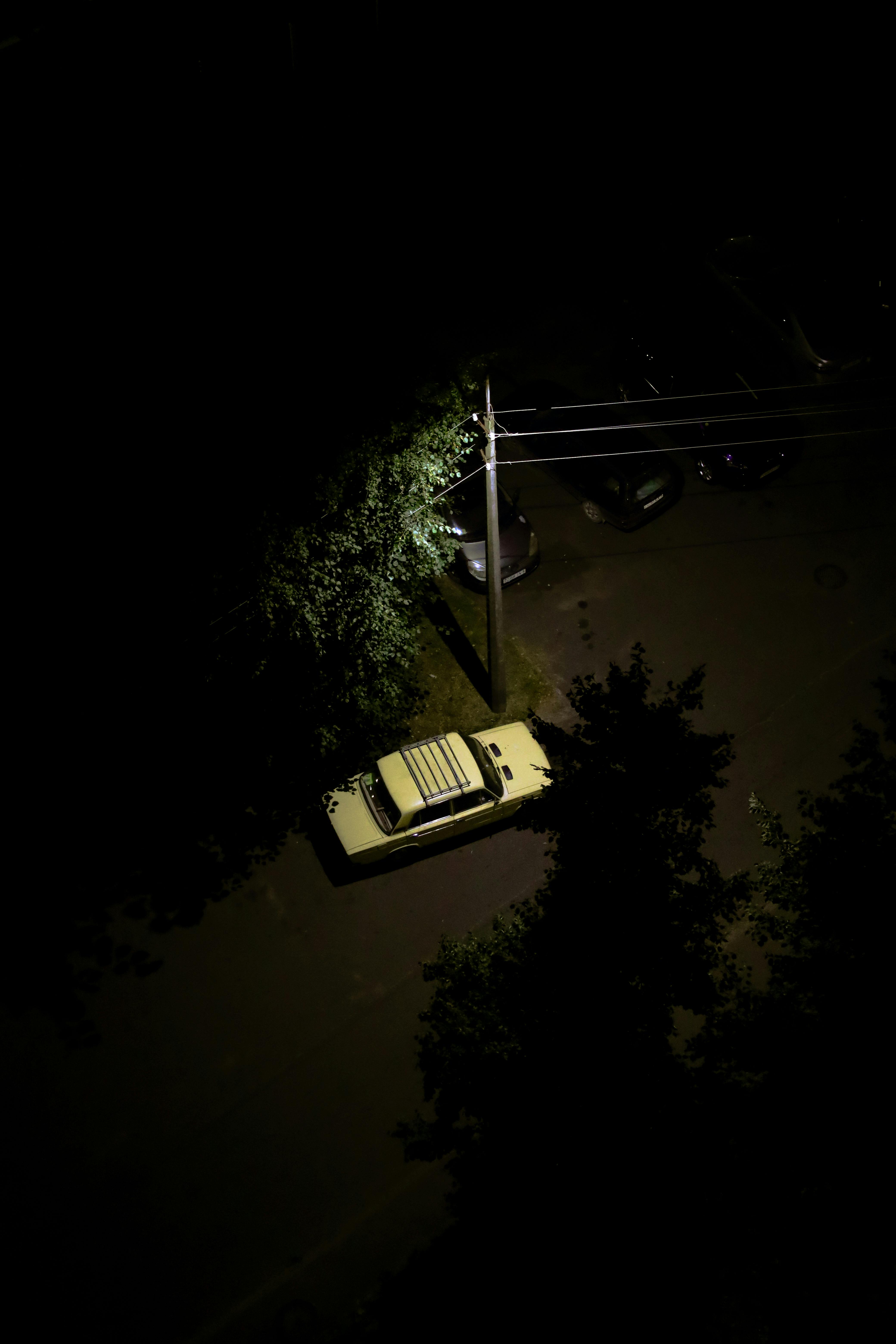 a car is parked in the middle of the road at night