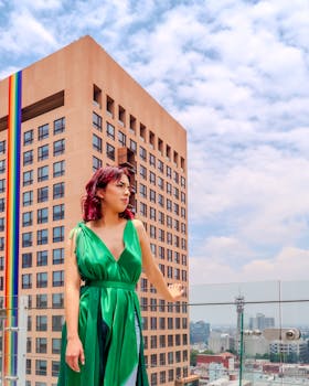 A confident woman in a green dress poses on a rooftop in Mexico City.