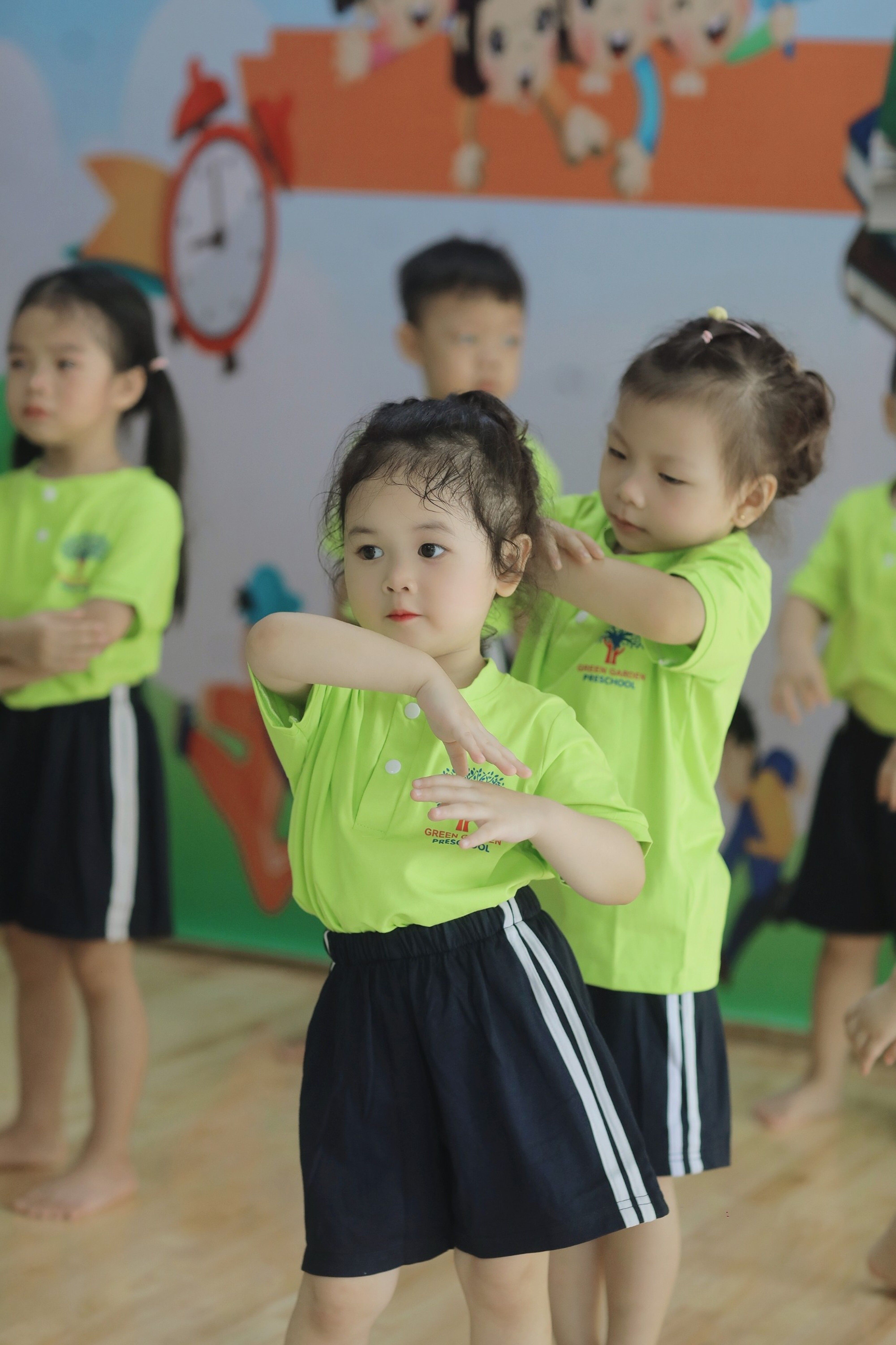 Kids enjoy a fun dance activity in a Vietnamese kindergarten classroom.