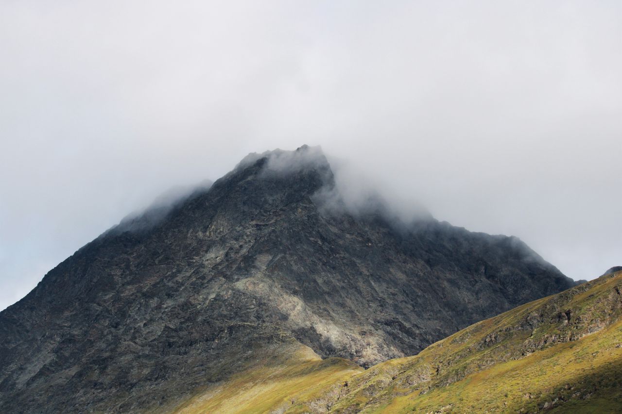 majestic mountain peak shrouded in mist showcasing a tranquil and rugg