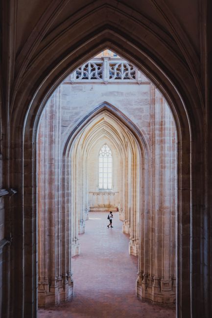 Intricate Gothic arches and architecture with soft natural light filtering through.
