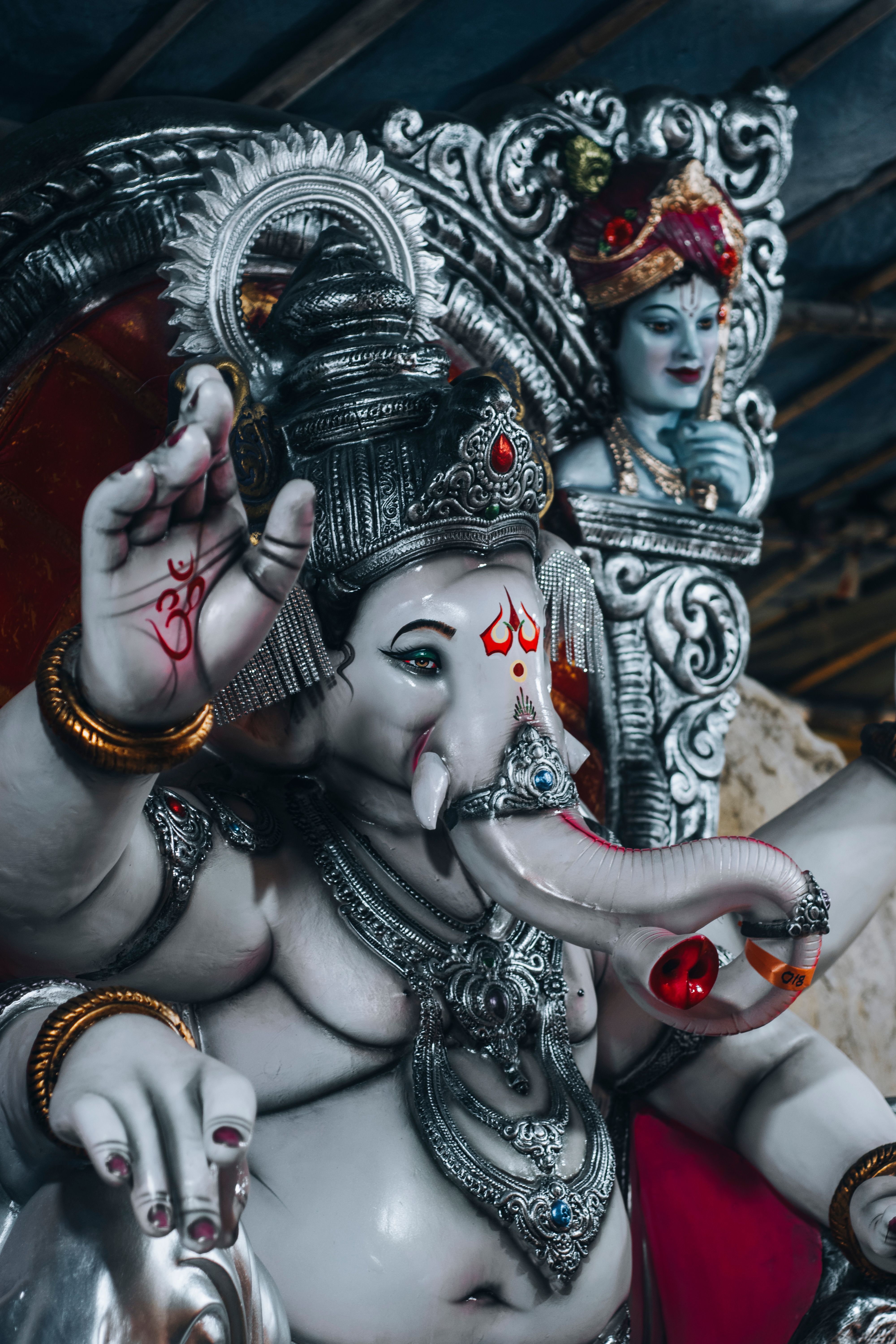 Ornate sculptures of Ganesh and a Hindu deity, symbolizing spirituality and culture.