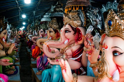 Free Colorful Ganesh idols lined up for Ganesh Chaturthi celebration at a workshop in India. Stock Photo