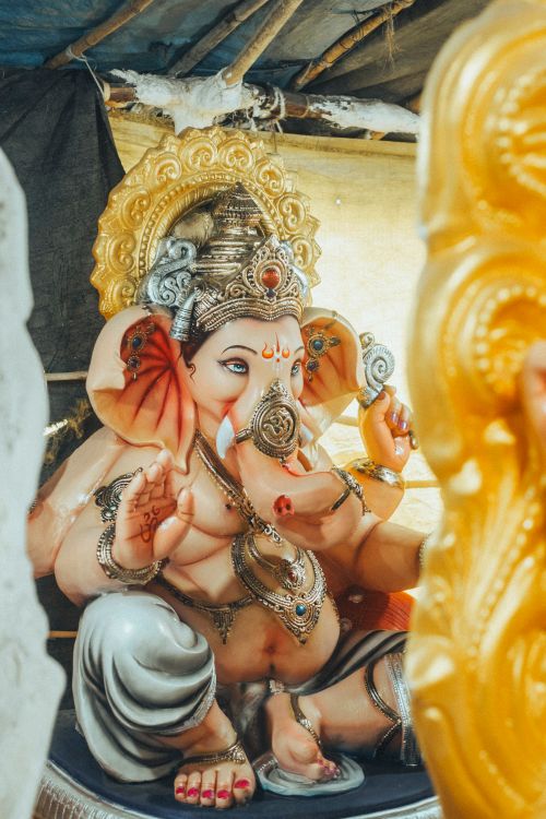 Free A detailed statue of the Hindu god Ganesha, showcasing traditional art and spirituality in an Indian temple. Stock Photo