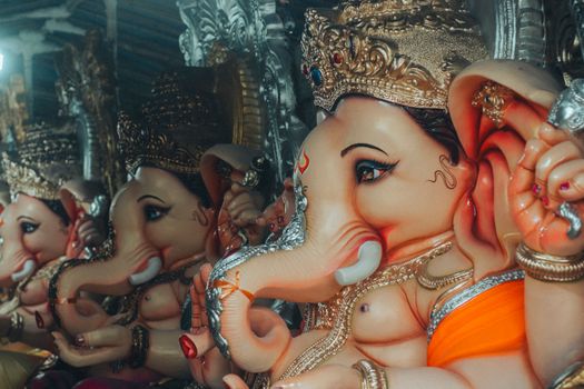 Captivating display of Ganesh statues during a vibrant Indian festival celebration.