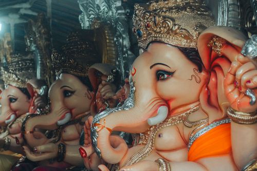 Free Captivating display of Ganesh statues during a vibrant Indian festival celebration. Stock Photo