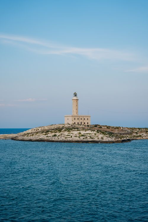 Free Idyllic view of the Vieste lighthouse standing tall on an Italian island, surrounded by blue Adriatic waters. Stock Photo