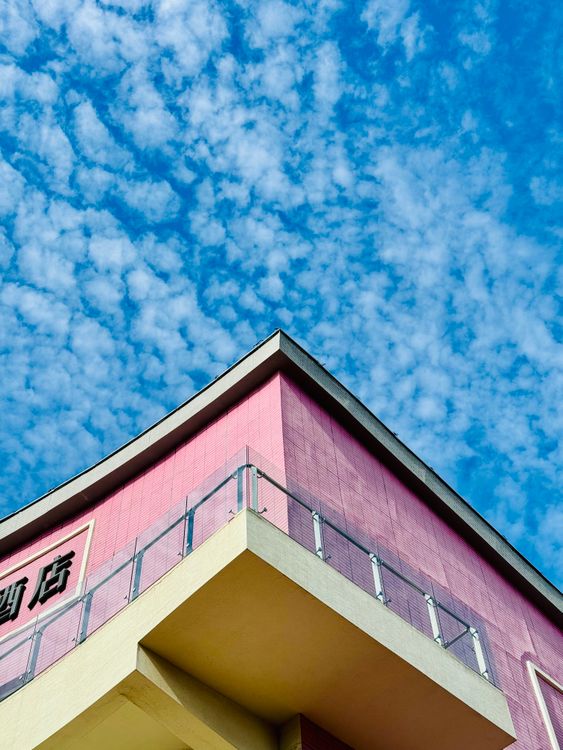 Pink Commercial Building Clouds Above Pink Building · Free Stock Photo