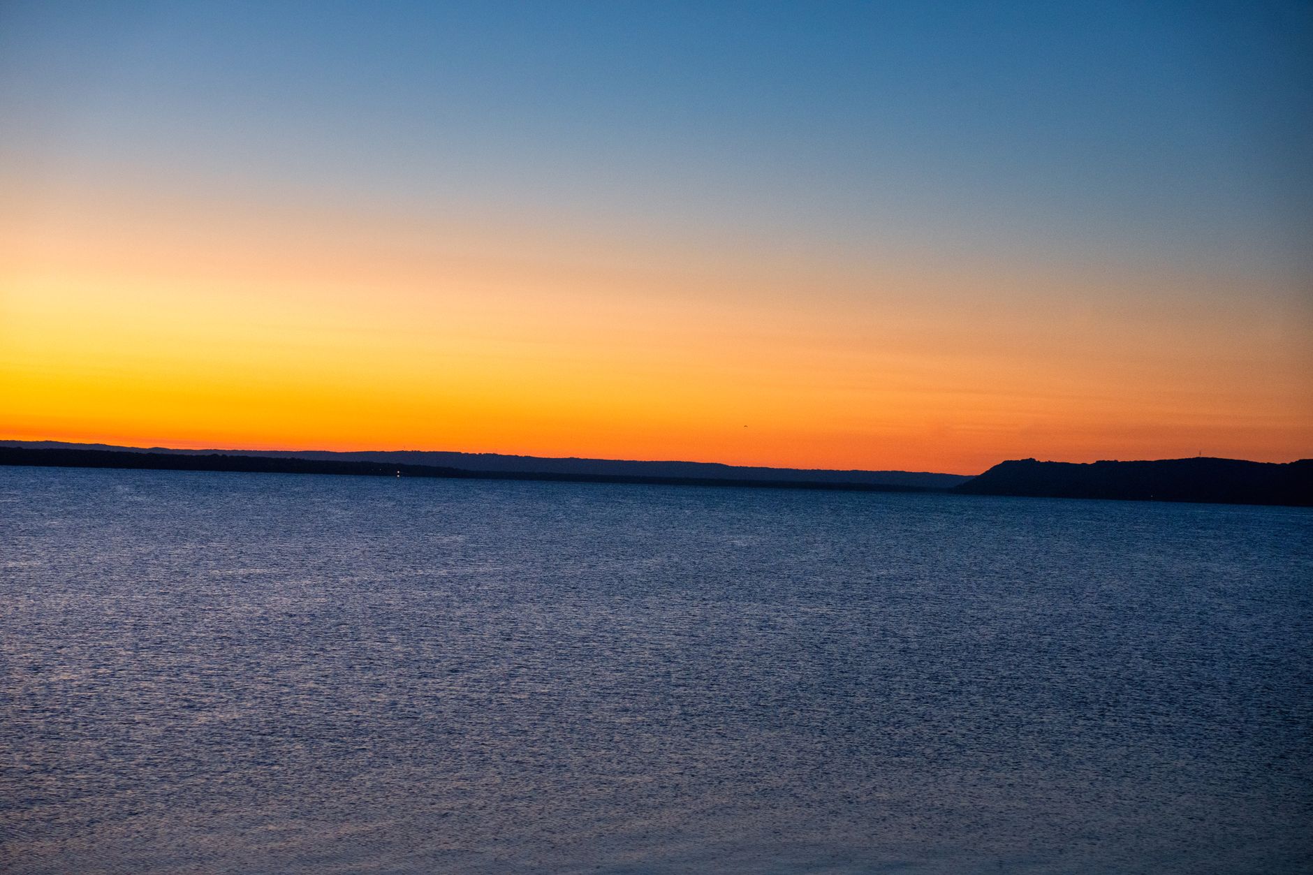 Beautiful sunset over Lake Pepin in Lake City, Minnesota featuring vibrant colors and serene water.