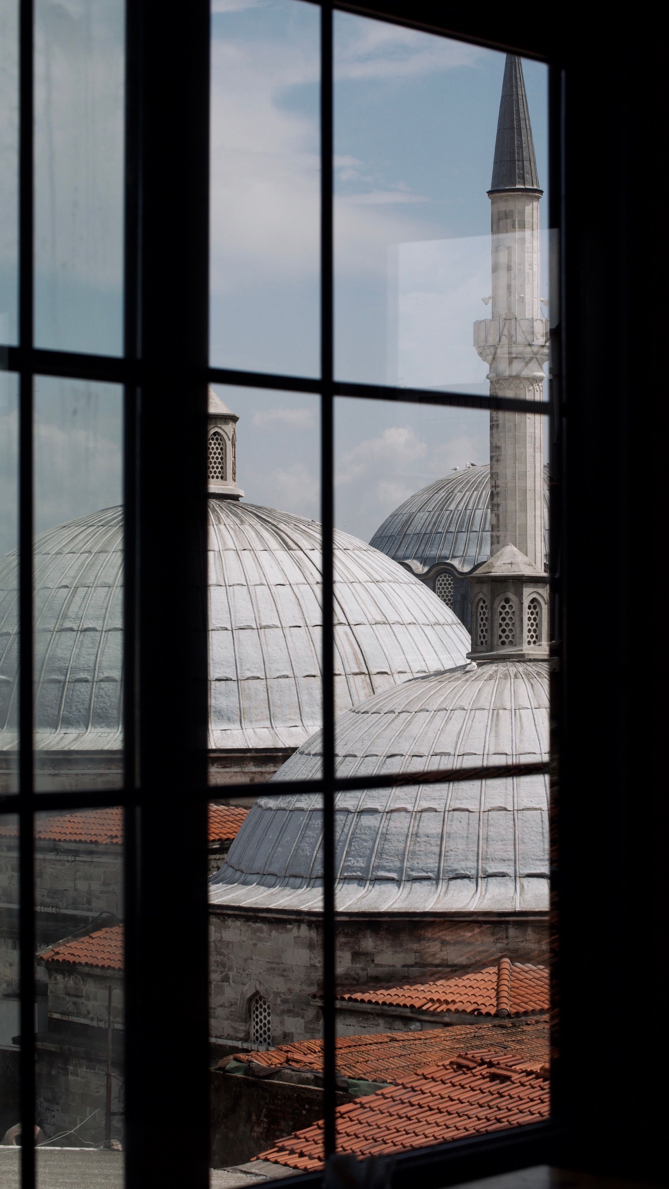 A window with a view of a mosque · Free Stock Photo