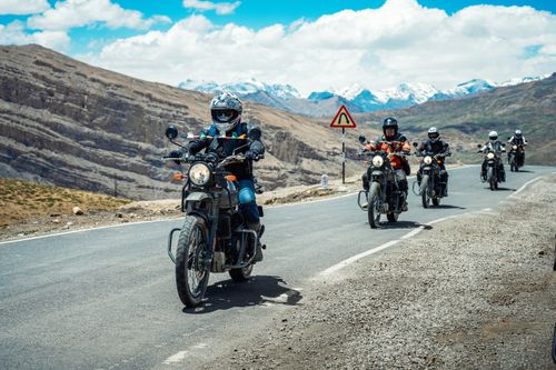 Free A group of motorcyclists ride through the stunning mountain landscapes of Spiti Valley, India. Stock Photo
