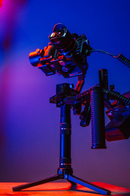 Free High-quality camera mounted on stabilizer with vibrant studio lighting for dynamic photography. Stock Photo