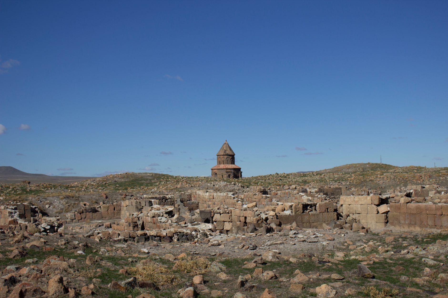 Explore the ruins of an ancient Armenian church with a scenic landscape in Kars, Türkiye.