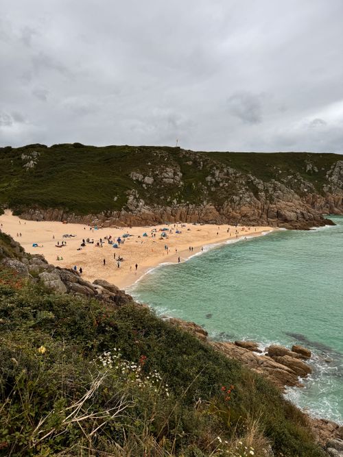 Free A breathtaking view of Porthcurno Beach in England with scenic cliffs and turquoise waters. Stock Photo