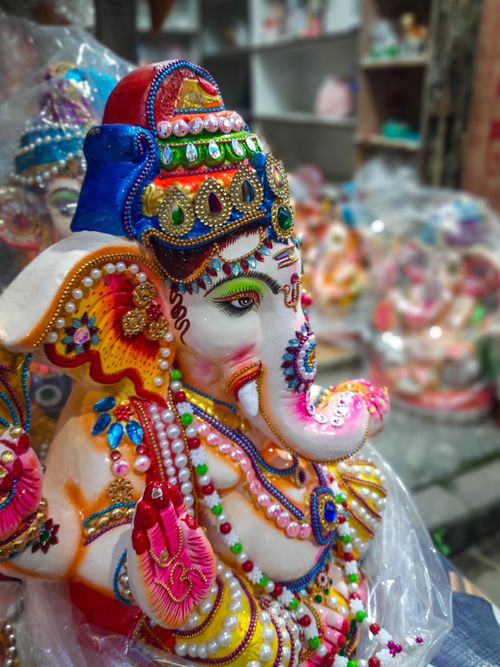 Free Vibrant Ganesh idol with intricate decor in a Kolkata market showcasing Indian festival artistry. Stock Photo