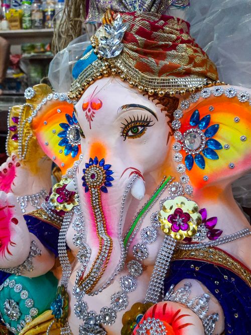 Free Colorful Ganesh idol adorned with jewels and fabric in Kolkata, capturing Indian festival spirit. Stock Photo