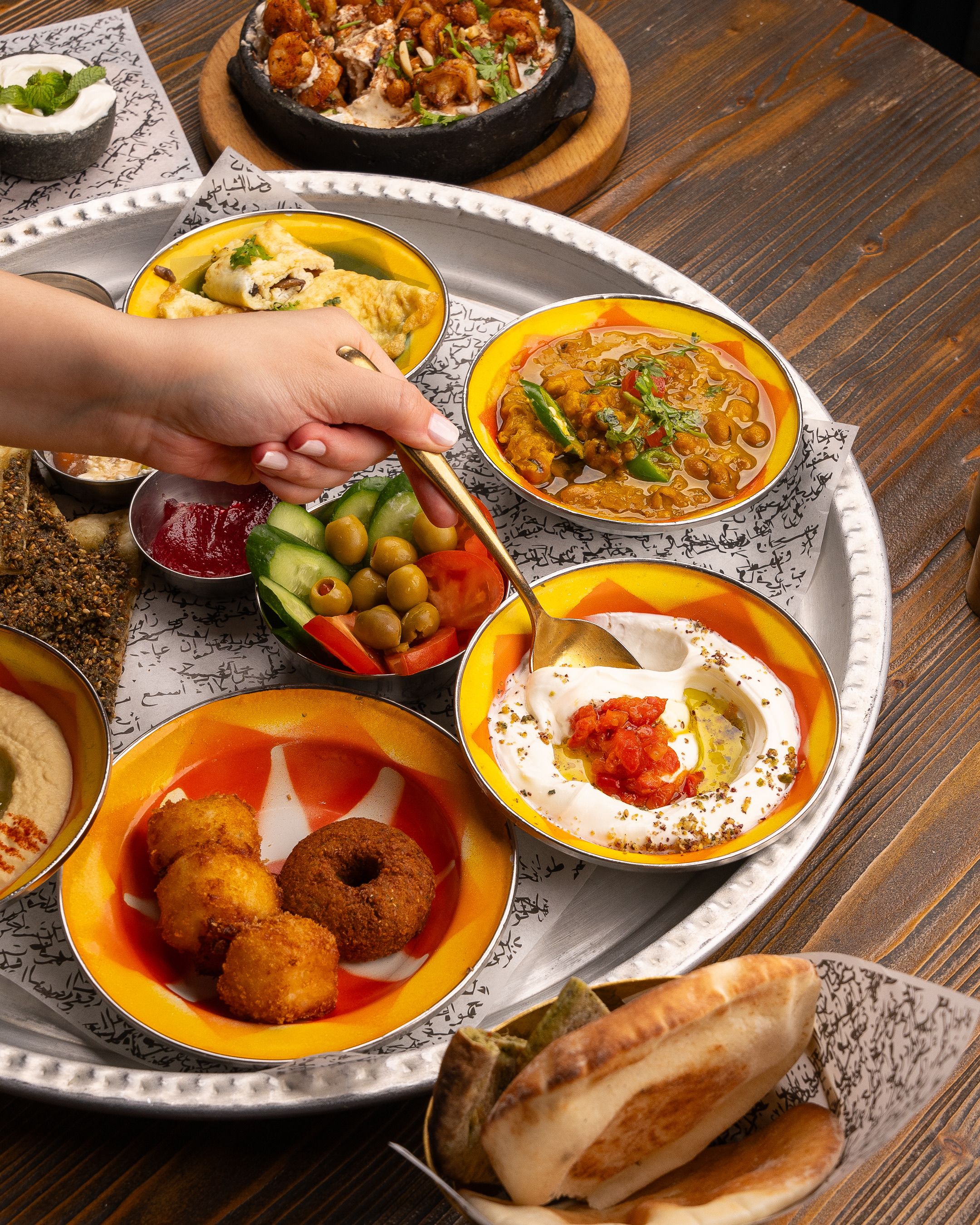 An array of traditional Middle Eastern dishes served on a platter, showcasing vibrant flavors and textures.