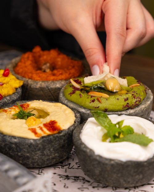 Free A variety of colorful and flavorful dips served with bread, perfect for a delicious lunch. Stock Photo