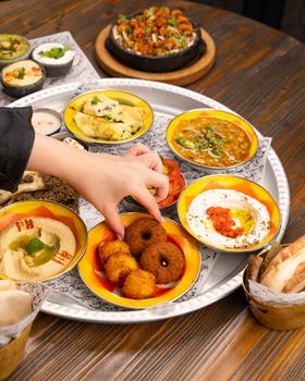 Enjoy a vibrant Middle Eastern mezze platter featuring a delightful assortment of traditional dishes.