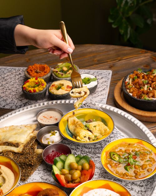 Free A vibrant assortment of Mediterranean dishes including hummus, salad, and pita bread. Perfect for culinary imagery. Stock Photo