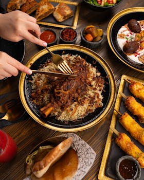 A delicious Middle Eastern meal featuring spiced rice, kebabs, and traditional sides.