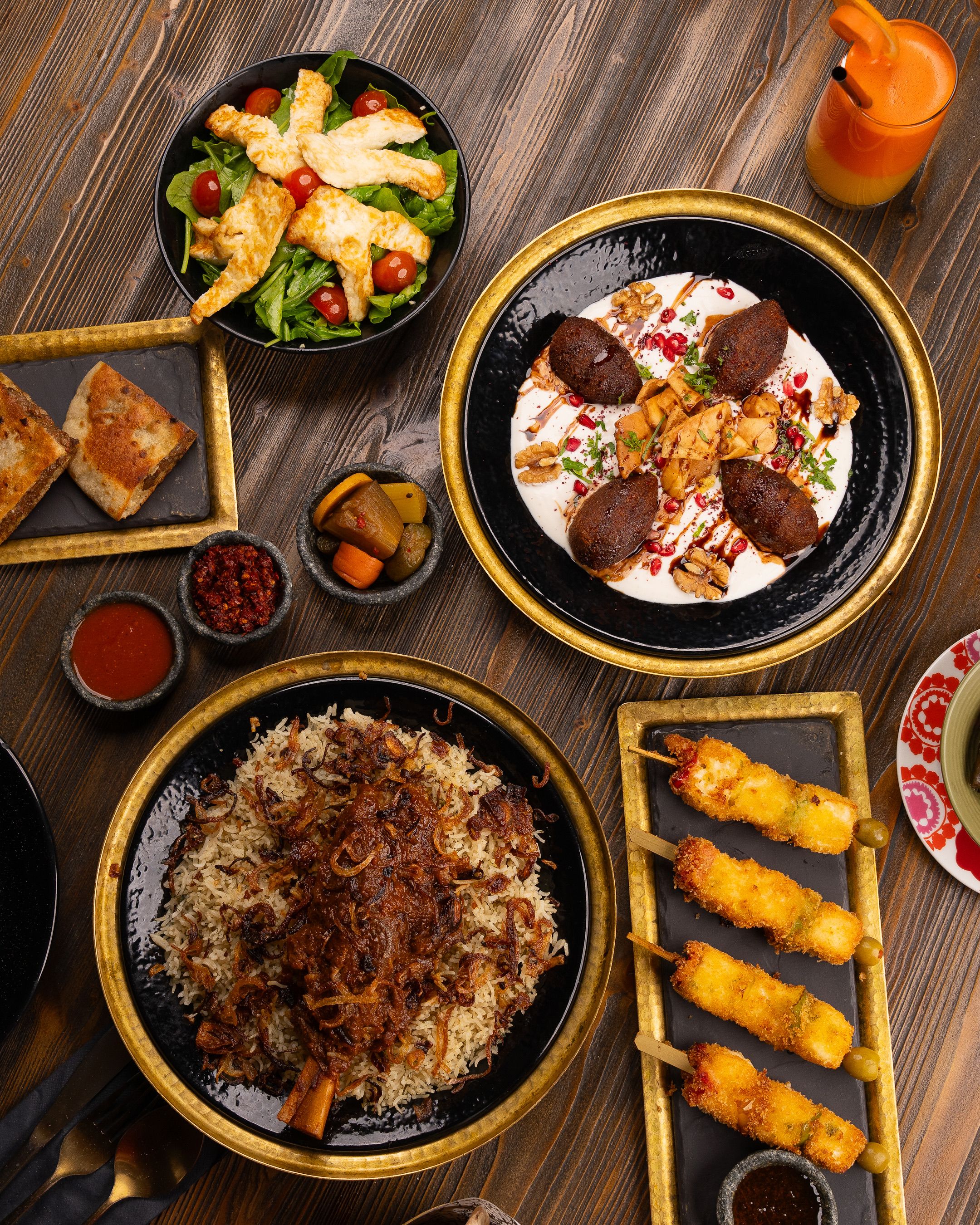 A delightful spread of Middle Eastern dishes including kibbeh, rice pilaf, and fresh salad, perfect for a luxurious meal.