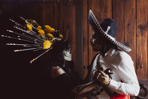 Free A vibrant depiction of Dia de los Muertos with traditional costumes and face paint. Stock Photo