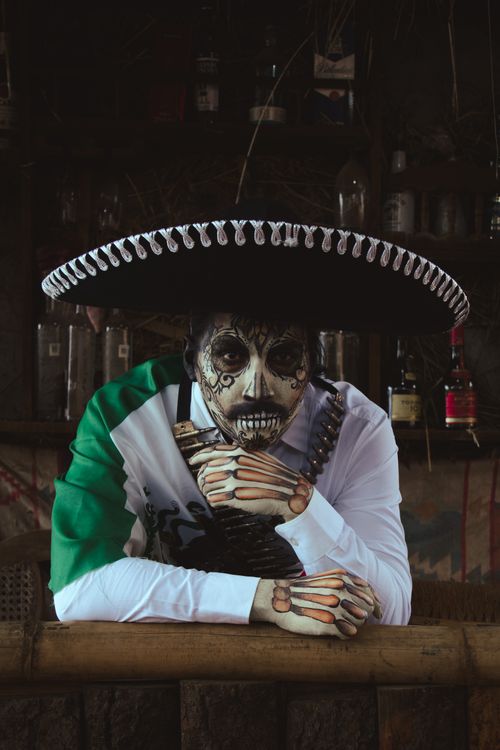 Free Portrait of a person in Day of the Dead costume with face paint and sombrero. Stock Photo