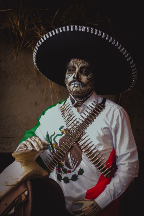 Free Man in a Mexican charro costume with skull makeup for Dia de los Muertos. Stock Photo