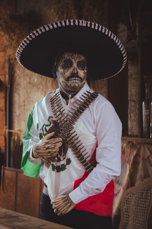 Free Man in Day of the Dead attire and face paint, symbolizing Mexican culture. Stock Photo
